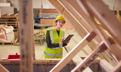 Female Safety Inspector With Digital Tablet At Construction Site