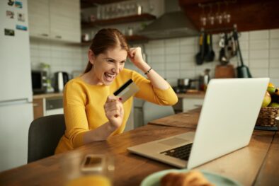 happy-woman-celebrating-while-checking-her-online-2022-12-13-06-57-39-utc-min