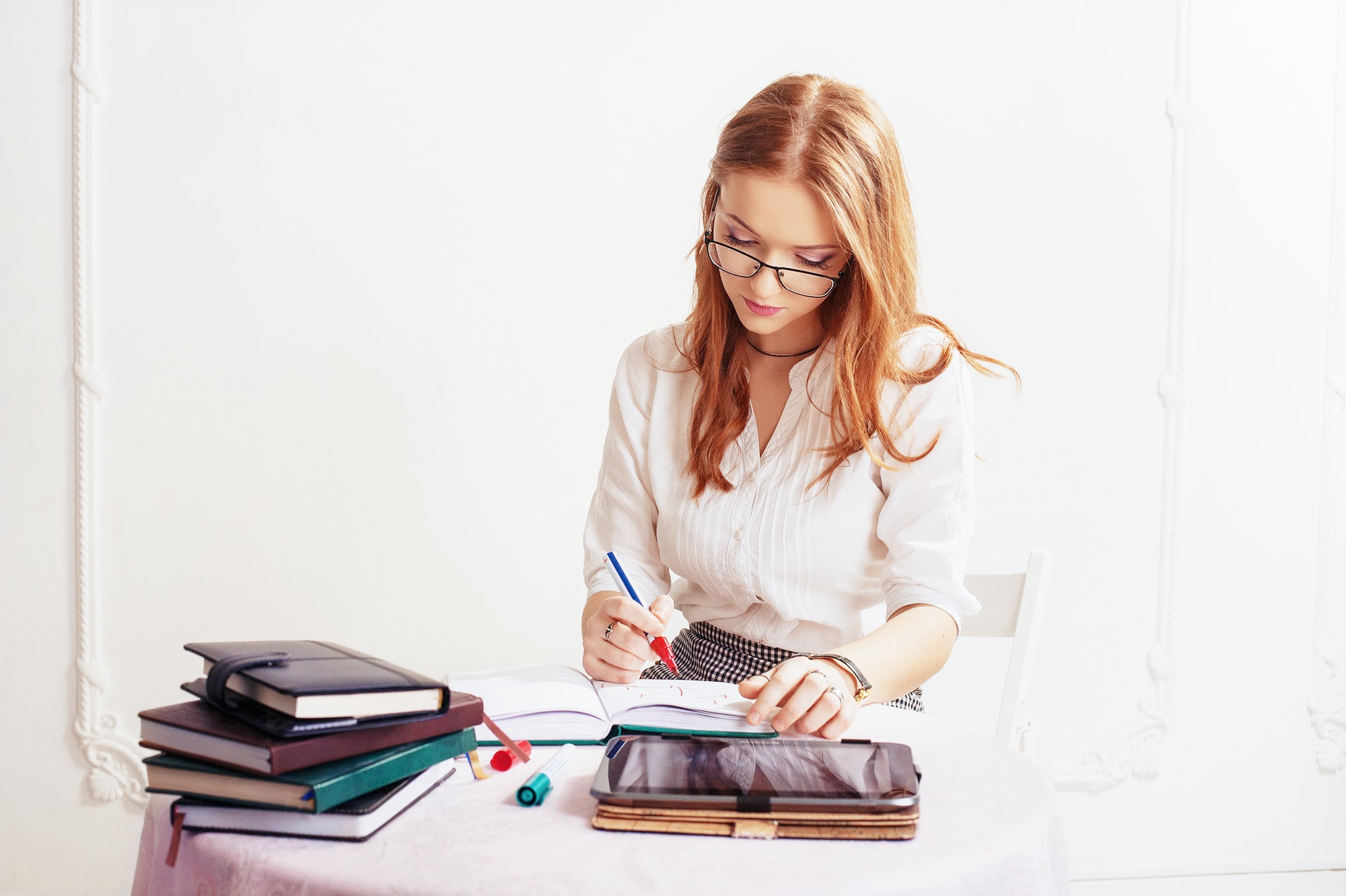 Business woman writes in notepad. The concept of business, jobs, education.