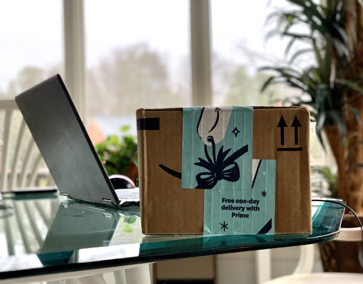 Delivered Amazon online order box next to laptop on a table