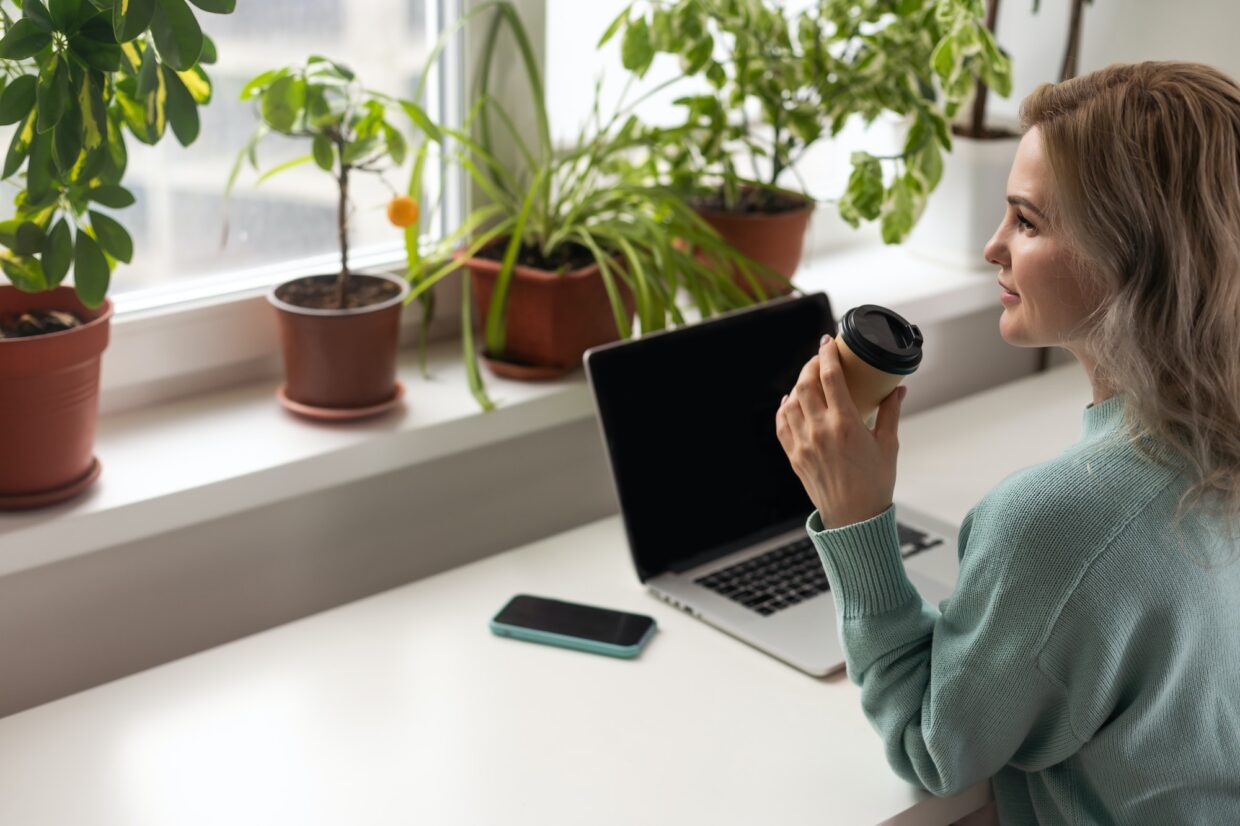 woman with laptop and takeaway coffee