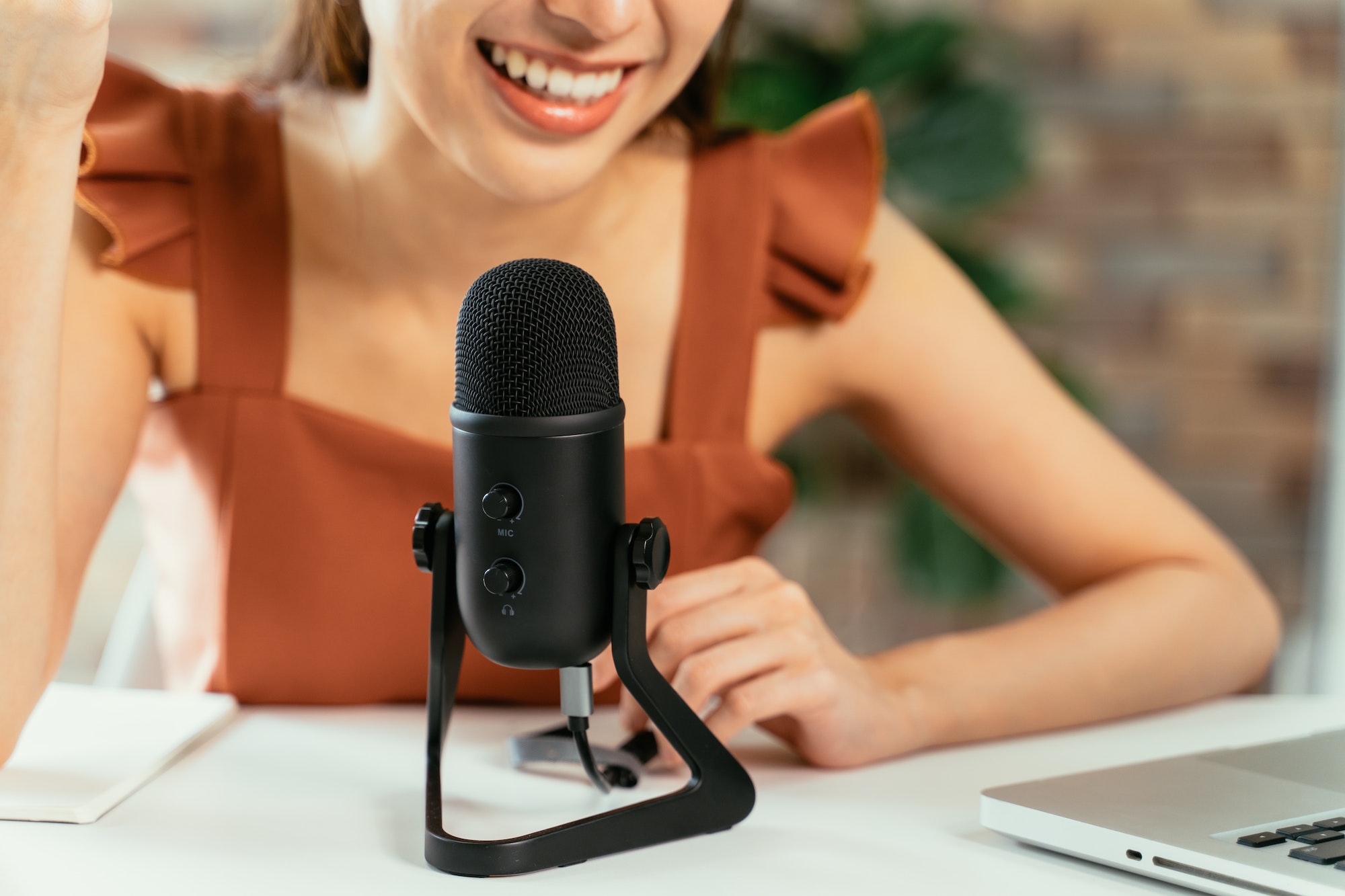 Woman with mic recording a podcast