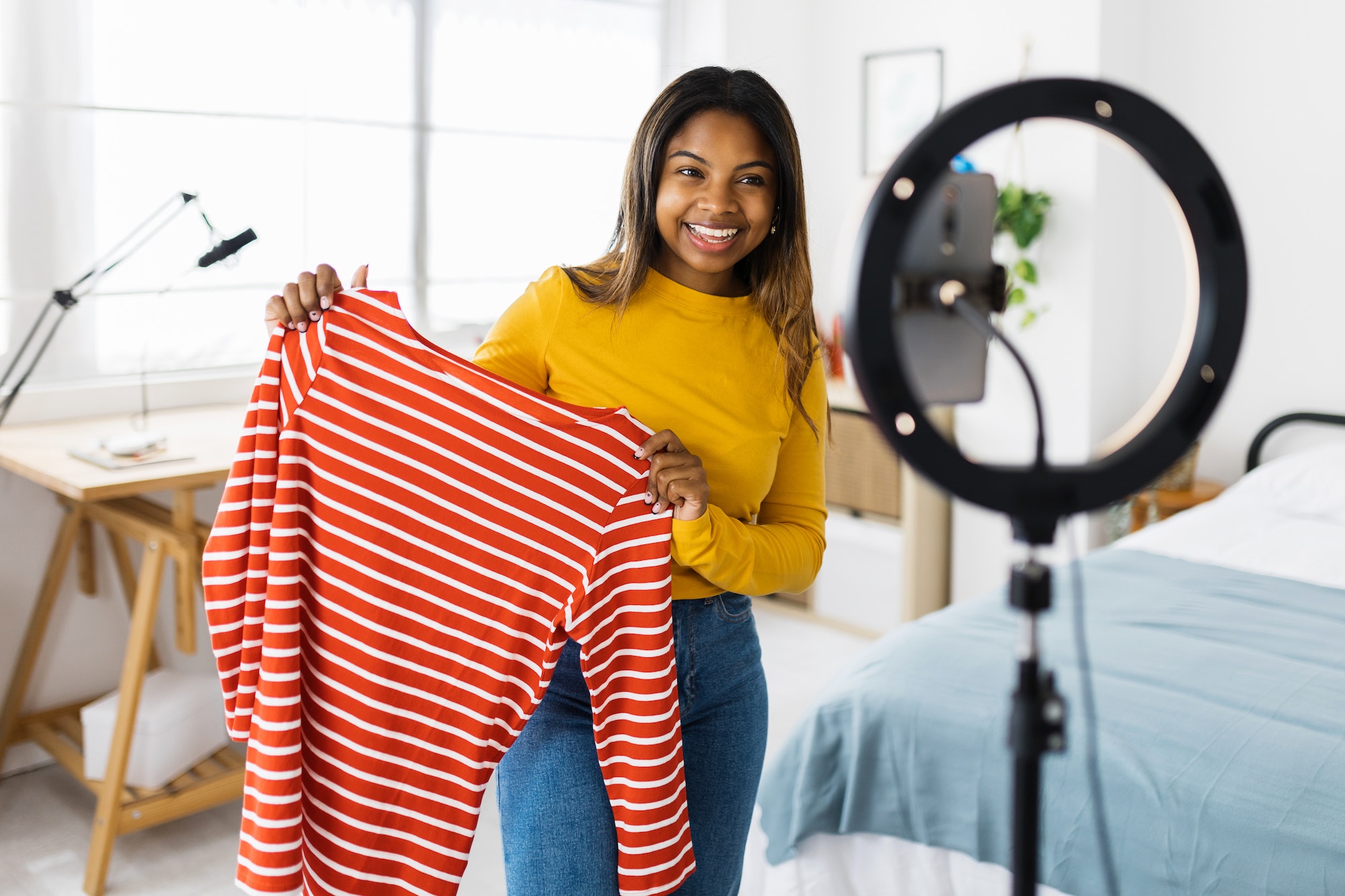 Young teen creator influencer girl recording video with mobile phone